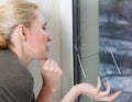 The sad young woman near a window