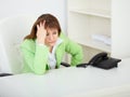A sad young woman in office at workplace Royalty Free Stock Photo