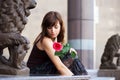 Sad young woman with a red rose Royalty Free Stock Photo