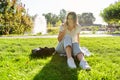 Sad young woman sitting alone in park making serious call Royalty Free Stock Photo