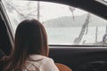 Sad young woman traveler inside the car in rainy day Royalty Free Stock Photo