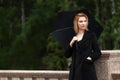 Sad young fashion woman with umbrella in the rain Royalty Free Stock Photo