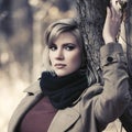 Sad young blonde fashion woman walking in autumn park Royalty Free Stock Photo