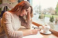 Sad young woman writing letter with broken heart Royalty Free Stock Photo