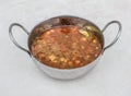 sada chanay, channay, chole or chickpeas curry served in karahi isolated on grey background side view of pakistani breakfast and