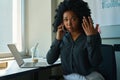 Saddened multiracial woman talking on the phone