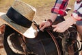 Saddle prepared for horse riding by young woman cowgirl Royalty Free Stock Photo