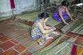 Women making traditional reed sleeping mats in Vietnam