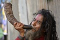 A sadhu or a monk playing Singha by blowing it in the Ganga Sagar Mela in Kolkata