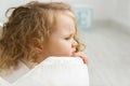 A sadness dreamy girl with curly hair in childroom