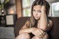 Sadness teen girl sits on sofa at home Royalty Free Stock Photo