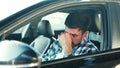 Sadness young man feeling stressed, sitting at driver seat in a car. Transport, people, lifestyle concept.