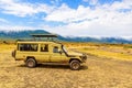 Safari Car in the Ngorongoro crater National Park with the Lake Magadi. Safari Tours in Savannah of Africa. Beautiful landscape