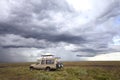 Safari car in the serengeti mara savanna before thunderstorm