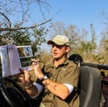 Safari Guide Ranger instructing guests about animals in a wildlife reserve