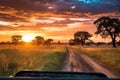 safari jeep driving through savannah sunset Royalty Free Stock Photo