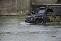 Safari suv. Off-road vehicle goes on the mountain. Expedition offroader. Jeep outdoors adventures. Tracks on a muddy Royalty Free Stock Photo