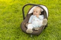 Baby in car seat on grass Royalty Free Stock Photo