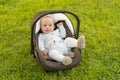 Baby in car seat on grass Royalty Free Stock Photo