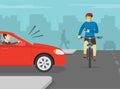 Cyclist is about to be hit by red sedan car while looking at phone on city road. Using a mobile phone while bicycle riding. Royalty Free Stock Photo
