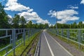 A safe bike and pedestrian path fenced on both sides with a fence. Royalty Free Stock Photo