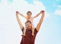 Safe on daddys shoulders. Portrait of a happy little girl and her father playing together in their backyard at home. Royalty Free Stock Photo