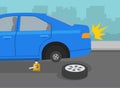 Safe driving tips and rules. Broken blue car on a city road. Changing flat tire using car jack. Royalty Free Stock Photo