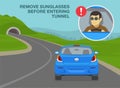 Remove sunglasses before entering tunnel. Car driving into mountain road tunnel. Royalty Free Stock Photo