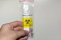 Safe handling of of rapid antigen COVID-19 testing specimen transport bag to throw in biohazard bin. Royalty Free Stock Photo