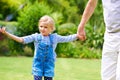 Safe in the hands of her granddad. an adorable little girl holding her grandfathers hand. Royalty Free Stock Photo