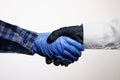 Safe handshake with protective rubber gloves symbol of modern times.