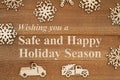 Safe and Happy Holiday Season message with wood snowflakes and retro trucks