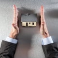 Safe home concept with straight businessman hands protecting new house Royalty Free Stock Photo