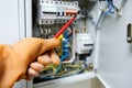 Safe operation in electrical installations with rubber glove on hand, red screwdriver on blurred background Royalty Free Stock Photo