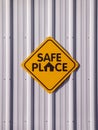 Yellow `Safe place` sign of a light metal wall Royalty Free Stock Photo