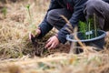 Safe the planet, man planting a tree in the ruined forest, help the planet, ecology concept Royalty Free Stock Photo