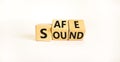 Safe and sound symbol. Turned wooden cubes and changed the word `safe` to `sound` or vice versa. Beautiful white background, c