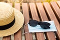 Safe Summer vacation. Sunglasses, mask and hat. Rest in the park Royalty Free Stock Photo