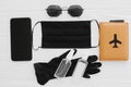 Safe travel in summer 2020. Black face mask, gloves, antiseptic and disinfectant, passport, sunglasses and phone on white Royalty Free Stock Photo