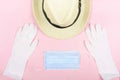 Safe travel from viruses concept,Hat with Medical face mask and white latex medical gloves isolated on pink background ,health Royalty Free Stock Photo