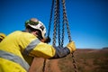 Safe work practices rigger wearing a leather safety glove hard hat head protection