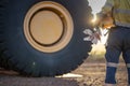 Safe work practises miner haul truck driver wearing work uniform safety glove holding hard hat locks prior start