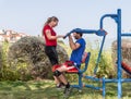 Two athletes perform exercises on outdoor public exercise machines in the open air in Zefat city in Israel