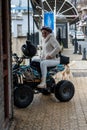 SAFED, ISRAEL - MARCH 25, 2022: Girl in a white jacket on a quad bike on the street