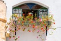 Decorated with blooming flowers and birds colorful stained glass window in Old Town of Safed, Israel