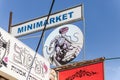 A sign on the minimarket with a painted Religious Jewish Superman with the sign of the city of Safed on his chest in the artists q