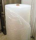 Safely Transporting Kitchen Goods roll of air-bubble packaging Royalty Free Stock Photo