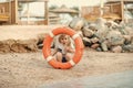 Safety on the beach. Boy child playing with life saver. Royalty Free Stock Photo