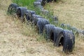 Safety border on a go-cart track made of old rubber tires embedded in the ground