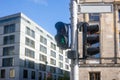 Safety concept for pedestrians. Green traffic light allows the walk through. Blue sky and buildings background Royalty Free Stock Photo